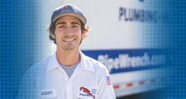 Portrait of Adam Bunch, a technician at Pipe Wrench, with professional tools.