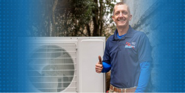 HVAC technician next to HVAC system in home.