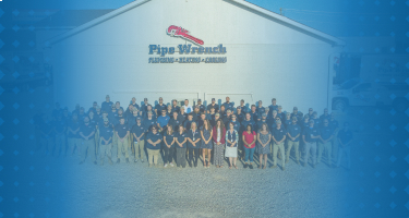 The Pipe Wrench Plumbing team posing together, representing dedication and professionalism