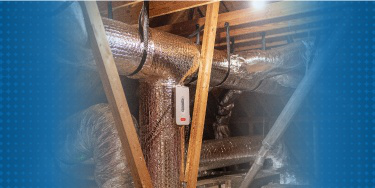 Technician repairing and replacing ductwork in a residential attic, ensuring efficient air flow.