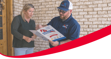 Plumber talking about Peace of Mind Program with homeowner.