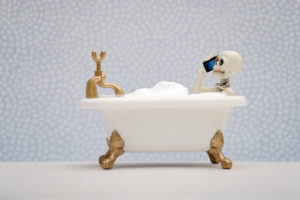 toy bathtub with skeleton on the phone