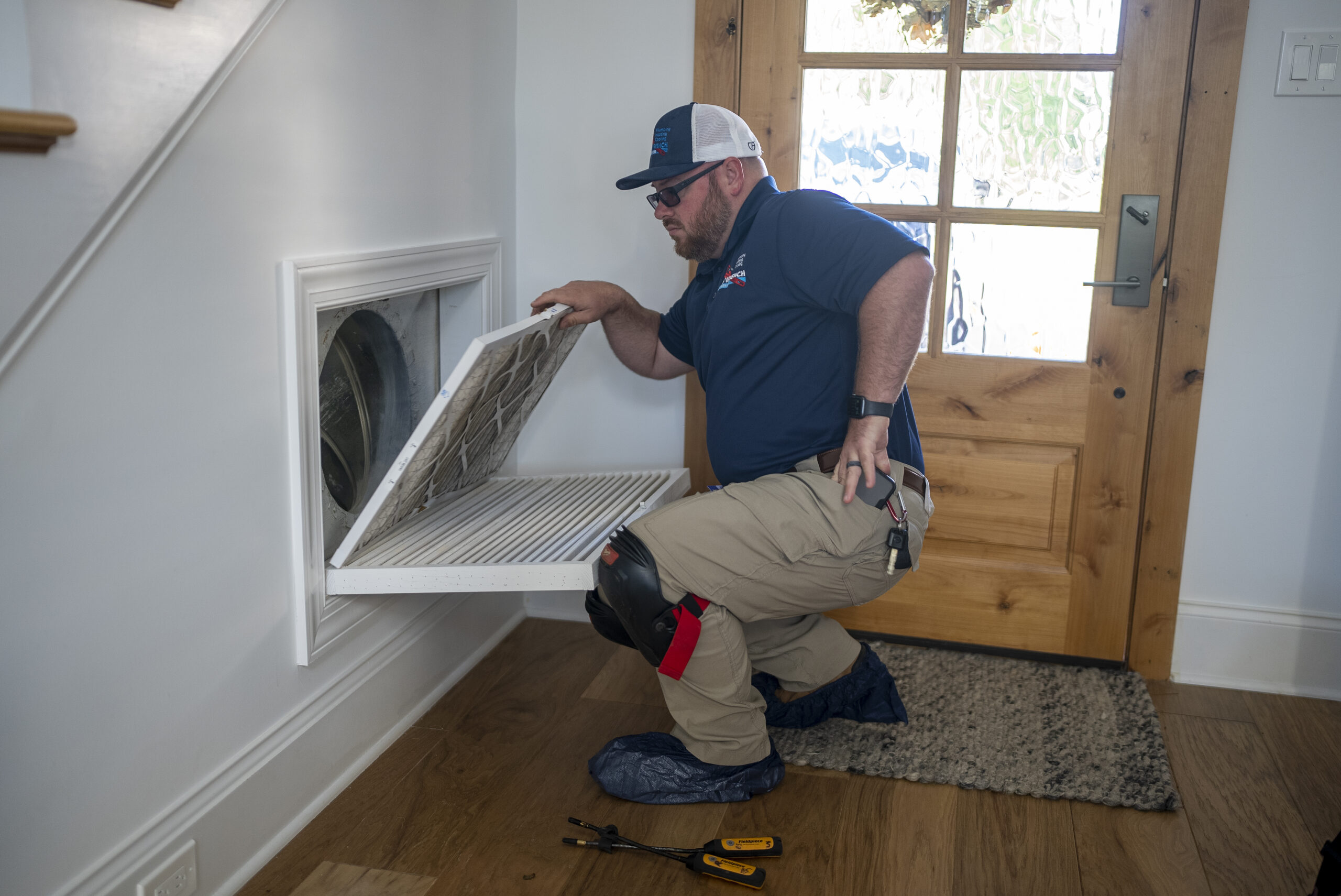 Technician inspecting a home's ductwork