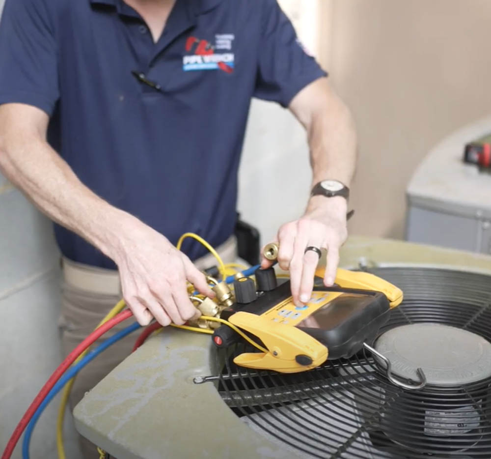 Technician using equipment to test and HVAC unit's performance.