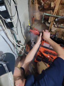 A plumber repairing a water pressure valve