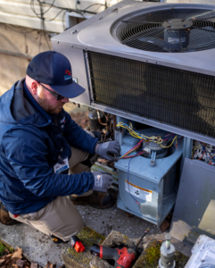 Technician repairing an HVAC outdoor unit.