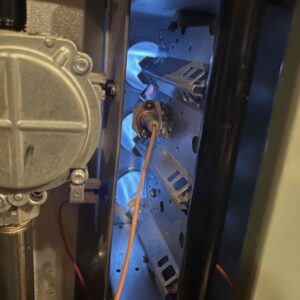 Technician performing maintenance on a furnace